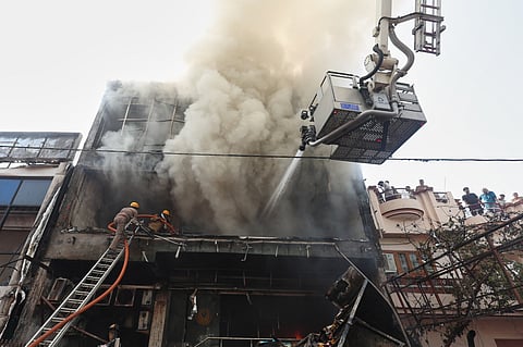 Firefighters work to put out a fire in a commercial building in Lucknow, India, Monday, 22 June 2026. 