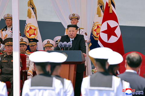In this photo provided by the North Korean government, its leader Kim Jong Un, center, speaks during a commissioning ceremony of its destroyer Choe Hyon at the port in Nampo Tuesday, 23 June 2026.