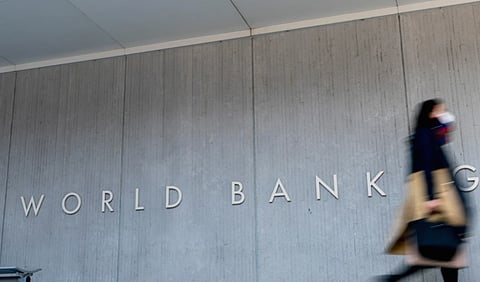 A woman walks past the World Bank building in Washington on April 5, 2021.
