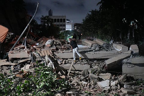 A man jumps on a collapsed building after an earthquake in Caracas, Venezuela, 24 June 2026.
