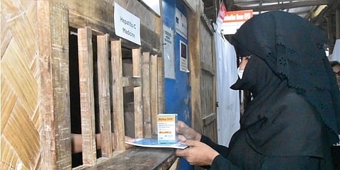 A confirmed hepatitis C patient receives life-saving medication at a WHO-supported treatment centre in Cox's Bazar.