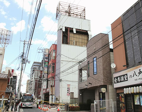 The wall of a building is seen partly damaged following an earthquake in Hachinohe, Aomori prefecture northern Japan, 25 June 2026. 