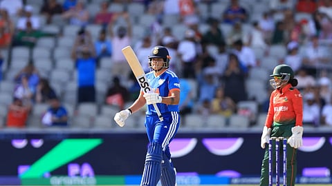 India's Shafali Verma lifts her bat after completing a half-century as Bangladesh captain Nigar Sultana looks on during their ICC Women's T20 World Cup Group 1 match in Manchester on Thursday.