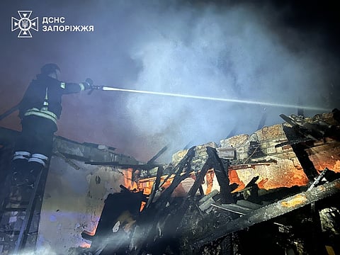In this photo, provided by the Ukrainian Emergency Service, firefighters extinguish a fire in a residential building following a Russian drone attack in Zaporizhzhia, Ukraine, 26 June, 2026.