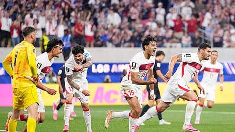 Turkey's Kaan Ayhan, right, celebrates scoring his side's third goal against the United States during a World Cup Group D match in California on Friday. 
