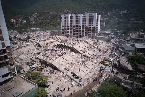Residents and rescue workers search through the rubble two days after an earthquake struck La Guaira, Venezuela