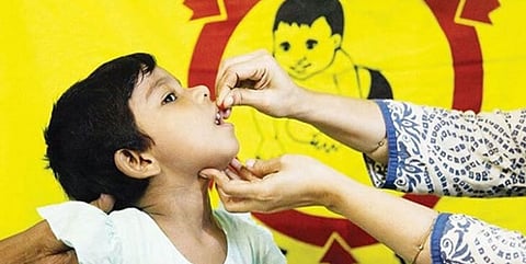 A healthcare worker administers a vaccine to a child.
