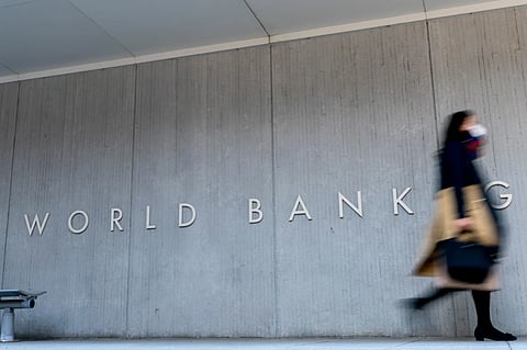 A woman walks past the World Bank building in Washington on April 5, 2021.