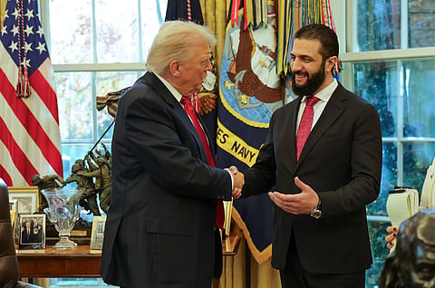 In this photo released by Syrian Presidency press office, President Donald Trump, left, shakes hands with Syria's President Ahmad al-Sharaa, at the White House in Washington, 10 Nov 2025.