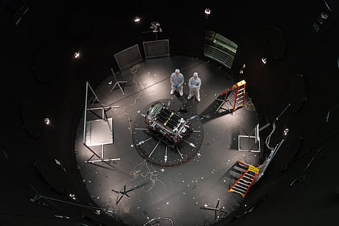 This photo provided by NASA shows Kieran Wilson, LINK’s principal investigator, and Hunter Robertson, a space systems engineer, both at Katalyst Space, standing next to their spacecraft inside the SES (Space Environment Simulator) at NASA’s Goddard Space Flight Center in Greenbelt, Md, 17 April 2026, ahead of thermal vacuum testing. 