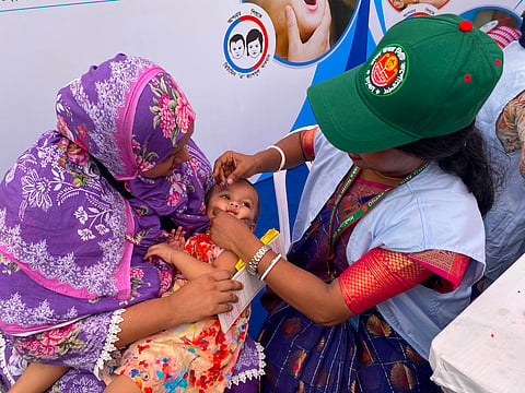 A healthcare worker administers a Vitamin A capsule to a child at a campaign centre in Mirpur 10 on Sunday.