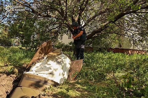 In this photo provided by the Ukrainian Emergency Service, a sapper examines a fragment of the Russian missile in a residential neighbourhood following an air attack in Kyiv, Ukraine, 28 June 2026. 

