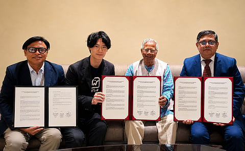Professor Yunus, alongside representatives of Japan's Wick Co, Ltd and Grameen Communications, hold up the MoU signed to develop 'Spark' on June 29, 2026.