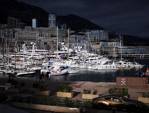 A luxury car drives along Monaco Harbor, 19 Nov 2020. 