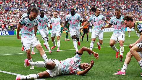 Belgium players celebrate after their third goal against Senegal in their Round of 32 match.