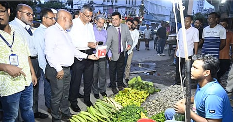 Bangladesh Bank Governor Md Mostaqur Rahman inaugurates Bangla QR by making a digital payment at a roadside vegetable stall on Wednesday.