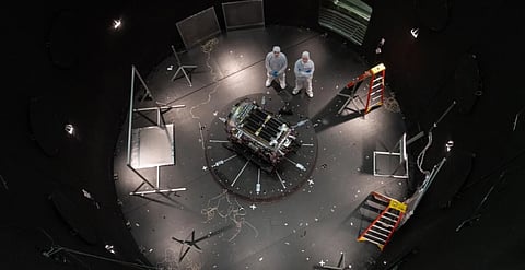 This photo provided by NASA shows Kieran Wilson, LINK’s principal investigator, and Hunter Robertson, a space systems engineer, both at Katalyst Space, standing next to their spacecraft inside the SES (Space Environment Simulator) at NASA’s Goddard Space Flight Center in Greenbelt, Md., April 17, 2026, ahead of thermal vacuum testing. 