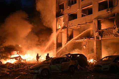 Emergency services personnel work to extinguish a fire following Russian missile attacks in Kyiv, Ukraine, 6 July 2026. 