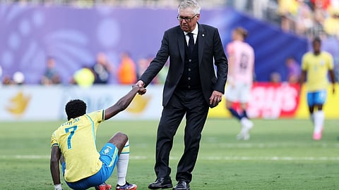 Brazil coach Carlo Ancelotti helps Vinicius Junior get up after the defeat to Norway in the Round of 16