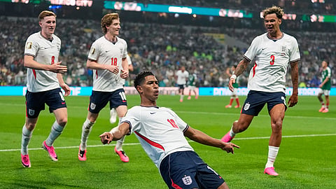 England's Jude Bellingham (10) celebrates with teammates after scoring his second goal during the World Cup Round of 16 match between Mexico and England in Mexico City on Monday.