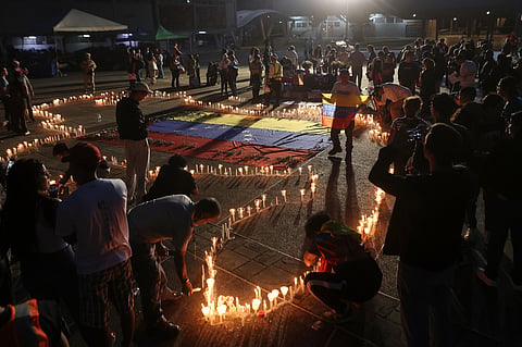 People hold a vigil for the victims of Venezuela's powerful twin quakes in Caracas, Venezuela, 5 July 2026.