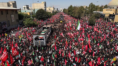 A truck carrying the coffins of the late Iranian Supreme Leader Ayatollah Ali Khamenei and members of his family makes its way through mourners during the funeral procession in Tehran, Iran, 6 July 2026. 