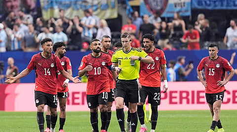 Egypt's Mohamed Salah remonstrates with referee Francois Letexier after Argentina's Enzo Fernandez scores their third goal