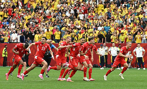 Switzerland's Djibril Sow and teammates celebrate after the penalty shootout as Switzerland qualify for the quarterfinals of the World Cup
