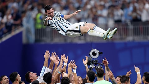 Argentina's Lionel Messi is thrown in the air in celebration by teammates after the match as Argentina qualify for the quarterfinals of the World Cup