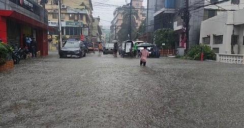 Commuters wade through knee-deep water in Chattogram after record 412.3mm rainfall inundated large parts of the city on Wednesday.