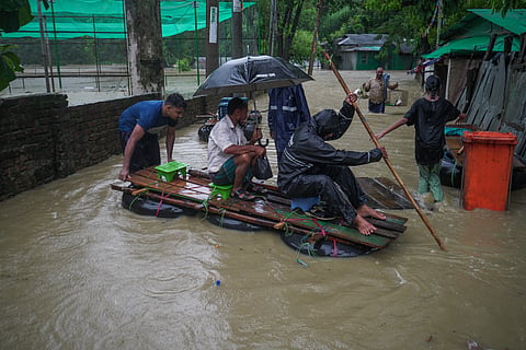 People wade through flood water in Bandarban on Thursay.