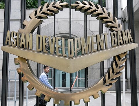 A worker walks past inside the Asian Development Bank (ADB) headquarters in Manila.