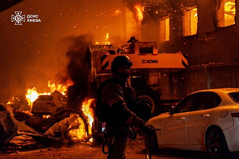 In this photo provided by the Ukrainian Emergency Service, emergency services personnel work to extinguish a fire following a Russian air attack in Kyiv, Ukraine, 8 July 2026.