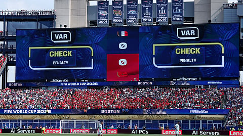 The big screen displays a VAR review message