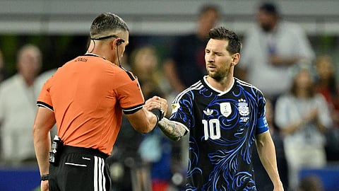 Argentina's Lionel Messi shakes hands with referee Istvan Kovacs after their group stage match against Jordan in Texas on June 27.