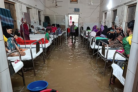 Floodwater inundates patient wards and cabins at Comilla General Hospital after heavy rainfall, disrupting healthcare services and forcing patients and attendants to navigate waterlogged conditions.
