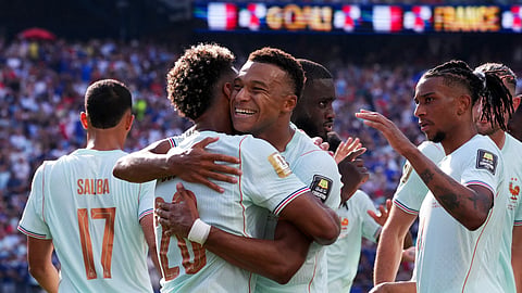 France's Kylian Mbappe celebrates scoring their first goal with Desire Doue and Michael Olise during their World Cup quarterfinal against Morocco in Boston on Monday