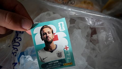Ines Mutri, 13, holds a trading card featuring England's Harry Kane before placing it in a freezer, as one of her superstitions, ahead of Argentina's FIFA World Cup 2026 semifinal against England, in Buenos Aires, Argentina, July 13, 2026.
