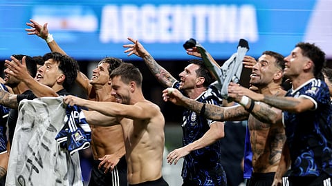 Argentina's Lionel Messi celebrates with teammates after the match as Argentina qualify for the final of the World Cup