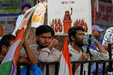 Supporters listen to a speaker during a protest by the Cockroach Janta Party demanding the resignation of Education Minister Dharmendra Pradhan over alleged examination irregularities and repeated paper leaks, in New Delhi, India, on 10 July 2026.  