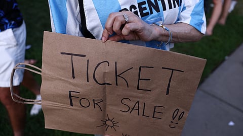 Argentina fan holds a sign for a match ticket as they gather in Kansas City ahead of their quarterfinal match against Switzerland