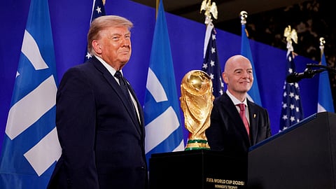 US President Donald Trump and FIFA President Gianni Infantino stand next to the FIFA World Cup Trophy, as they attend a FIFA reception at Trump Tower in New York City, US, July 17, 2026