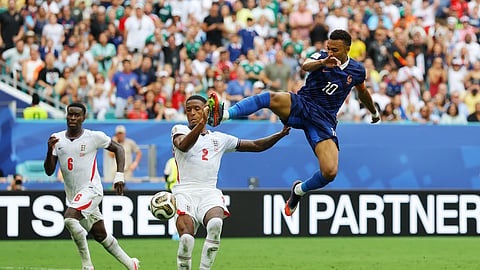France's Kylian Mbappe in action with England's Ezri Konsa in the third-place decider
