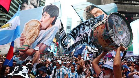 Argentina fans play drums as they gather in Times Square a day before the FIFA World Cup final between Spain and Argentina