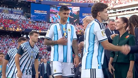 Argentina's Cristian Romero walks away with the runners-up medal, without shaking US president Donald Trump's hand in the presentation ceremony after the World Cup final on Monday. 