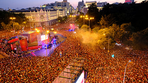 Spain fans gather at Cibeles Square in Madrid during the victory parade as they celebrate after winning the World Cup