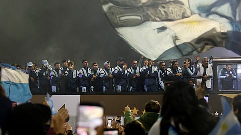 Argentina players wave to fans as they arrive at the Argentine Football Association (AFA) headquarters on the outskirts of Buenos Aires after losing the FIFA World Cup final to Spain