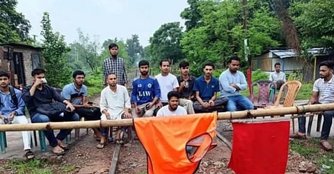 Students block the railway line near the university campus