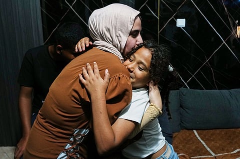 Mais Al-Gharam hugs her 8-year-old sister Arjwan, who was granted an Israeli passport, in her home in Nazareth, Israel, Wednesday, July 8, 2026, after Arjwan's arrival from the Gaza Strip. 