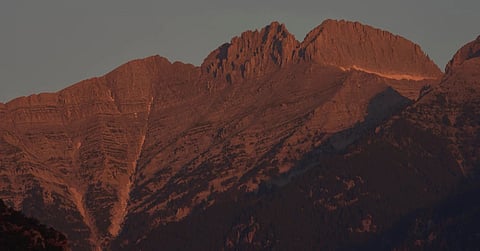 The morning light shines on Mytikas, Greece's highest peak, center left, and Stefani, known as the Throne of Zeus, center right, atop Mount Olympus seen from the outskirts of Litochoro in northern Greece, Wednesday, July 15, 2026.